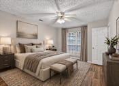 Thumbnail 7 of 14 - A bedroom with a large bed, a ceiling fan, and a painting on the wall.