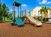 Thumbnail 8 of 24 - A playground with a green slide and a yellow slide.