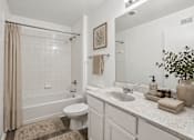 Thumbnail 24 of 25 - A bathroom with a toilet, sink, and shower.