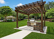 Thumbnail 7 of 25 - A wooden pergola is over a stone and tile covered table.