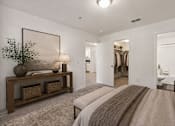 Thumbnail 19 of 25 - A bedroom with a large bed and a painting on the wall.