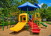 Thumbnail 5 of 25 - A playground with a yellow slide and a blue roof.