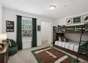 Thumbnail 22 of 25 - A room with a bunk bed and a football themed rug.