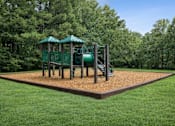 Thumbnail 3 of 15 - A playground with a green slide and a brown sandbox.