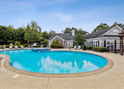 Thumbnail 3 of 22 - A large swimming pool in front of a house.