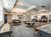 Thumbnail 10 of 26 - Community clubhouse with game tables and seating areas at The Beckstead Apartments, Utah, 84095