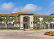Thumbnail 2 of 26 - a building with palm trees in front of it