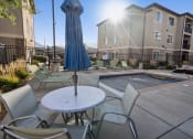 Thumbnail 18 of 31 - our apartments have a pool and a patio with chairs and an umbrella