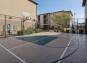 Thumbnail 21 of 31 - an outdoor basketball court in front of a building