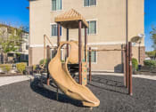 Thumbnail 16 of 31 - a playground with a slide in front of a building