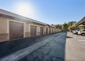 Thumbnail 31 of 31 - a row of garages and cars parked outside of a building