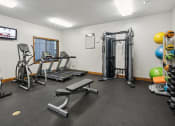 Thumbnail 23 of 31 - the gym with weights and cardio equipment at the apartments