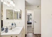 Thumbnail 17 of 24 - A bathroom with a white sink and a mirror above it.