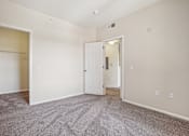 Thumbnail 16 of 36 - A room with a carpeted floor and two doors.