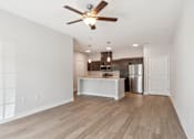 Thumbnail 36 of 36 - A room with a ceiling fan and wooden flooring.