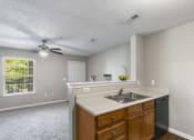 Thumbnail 3 of 29 - a kitchen with a sink and a ceiling fan