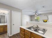 Thumbnail 14 of 29 - a kitchen with a sink and a ceiling fan