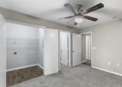 Thumbnail 6 of 29 - an empty bedroom with a ceiling fan and a closet