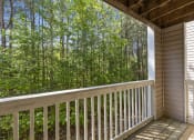 Thumbnail 24 of 29 - a view of the woods from the balcony of a cabin