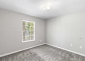 Thumbnail 10 of 29 - an empty room with carpet and a window