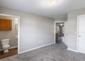 Thumbnail 5 of 29 - an empty room with a toilet and a hallway to a bathroom