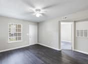 Thumbnail 9 of 29 - an empty living room with a ceiling fan and a window