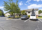 Thumbnail 27 of 29 - a parking lot with cars in front of a house