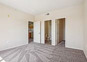 Thumbnail 17 of 36 - A room with carpeted floor and three open doors.
