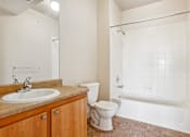 Thumbnail 20 of 36 - A bathroom with a sink, toilet, and bathtub.