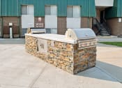 Thumbnail 18 of 35 - an outdoor grill with a building in the background