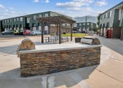 Thumbnail 17 of 35 - a building with a picnic area and a brick fireplace