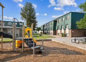Thumbnail 22 of 35 - a playground with a play set in front of a building
