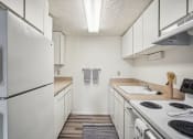 Thumbnail 1 of 35 - an empty kitchen with white appliances and white cabinets