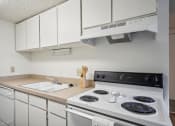 Thumbnail 15 of 35 - a kitchen with a stove top oven and a sink