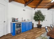 Thumbnail 25 of 35 - a kitchen with blue cabinets and a table and chairs