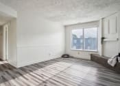 Thumbnail 2 of 35 - an empty living room with wood floors and a window