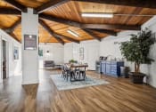 Thumbnail 24 of 35 - a living room with a wooden ceiling and a dining room table