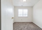 Thumbnail 11 of 35 - an empty bedroom with carpet and a window