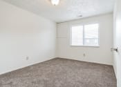 Thumbnail 10 of 35 - an empty room with carpet and a window
