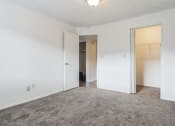 Thumbnail 9 of 35 - an empty bedroom with white walls and a door to a closet