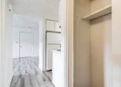 Thumbnail 5 of 35 - an empty kitchen with white cabinets and a wood floor