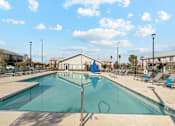 Thumbnail 11 of 36 - A large outdoor swimming pool with a blue flag in the middle.