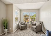 Thumbnail 2 of 24 - A sunny room with two chairs and a table.