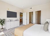 Thumbnail 4 of 36 - A bedroom with a large bed, a TV, and a cabinet.