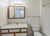 Thumbnail 20 of 34 - a bathroom with a toilet sink and mirror and a shower