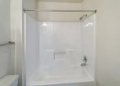 Thumbnail 22 of 34 - a white bathroom with a shower and a sink