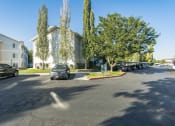 Thumbnail 29 of 34 - a parking lot with cars parked in front of a building