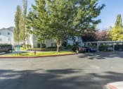 Thumbnail 31 of 34 - a parking lot with cars parked in front of an apartment building
