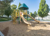 Thumbnail 24 of 34 - a playground with a slide in a park