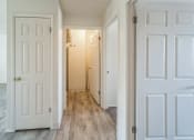 Thumbnail 14 of 34 - an empty hallway with white doors and a closet